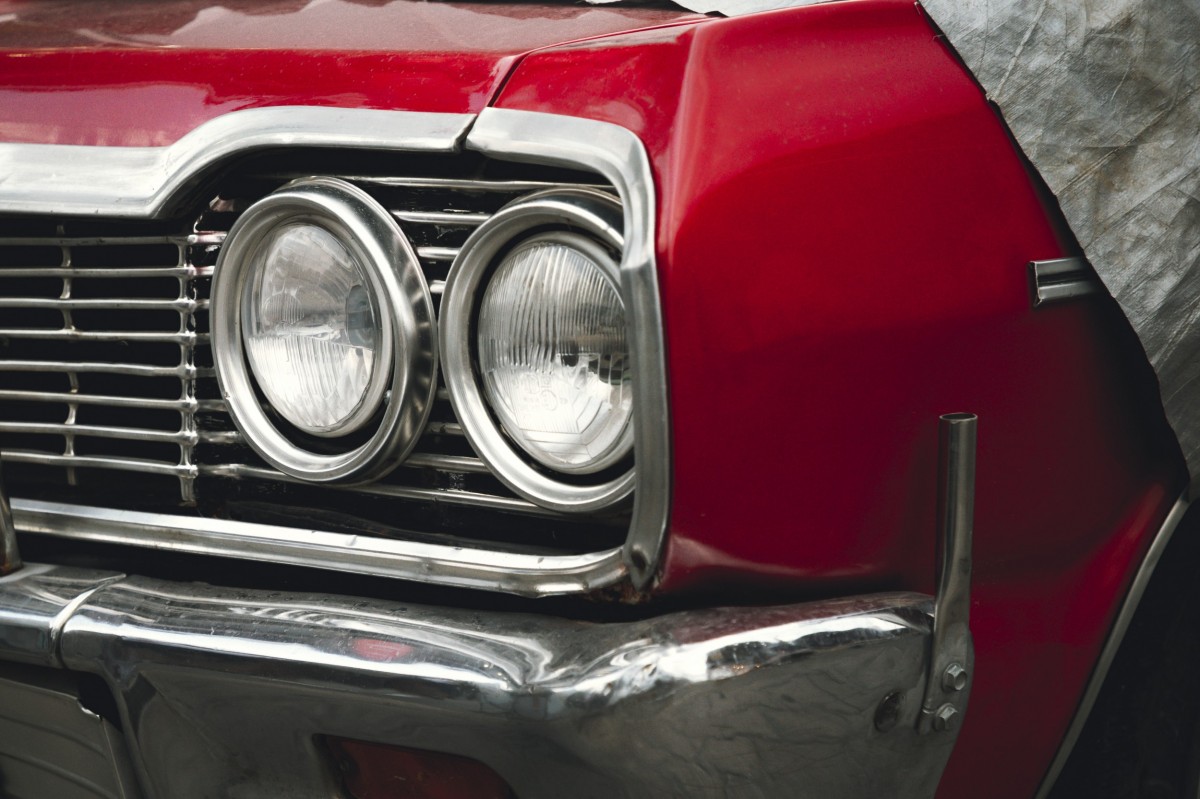 classic car with tarp over hood